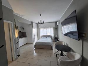 a bedroom with a bed and a table and chairs at Beach apartment's in Limassol