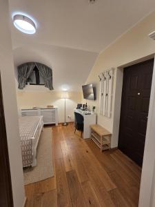 a bedroom with a bed and a desk with a computer at Silent Retreat, Boutique Suite inside Monastery in Suceava
