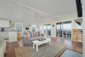 a living room with a couch and a table at 7916 - Hatteras Vista in Hatteras +35 photos