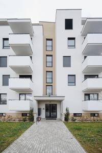 an apartment building with a white facade at Castle view Vinetto apartment with free parking in Trenčín