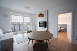 a living room with a table and a couch at Castle view Vinetto apartment with free parking in Trenčín