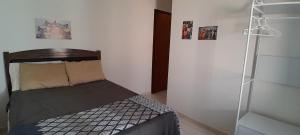 a small bedroom with a bed and a ladder at Suíte aconchego in Guaratuba
