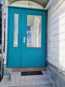 a blue door on a house at Wohnung Werratal Blick in Dankmarshausen +8 photos