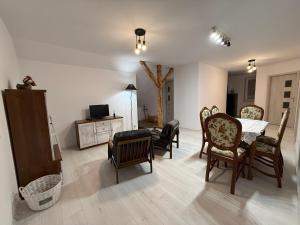 a living room with chairs and a bed and a television at Apartament u Buki Zator, Skawina, Kraków in Pozowice