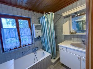 a bathroom with a tub and a sink and a window at Landhaus Sunnberg in Gersdorf +42 photos