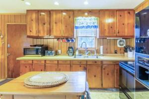 a kitchen with wooden cabinets and a wooden table at 7602 - Drydock in Avon