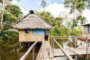 a small hut on a wooden bridge in the water at Red Uakari Jungle Lodge in Iquitos