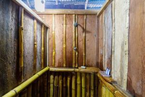 a room with a wooden wall with pipes at Red Uakari Jungle Lodge in Iquitos