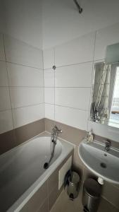 a bathroom with a bath tub and a sink at atelier in Bratislava