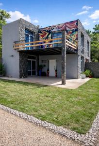 a house with a mural on the side of it at El Pedregullo in Neuquén