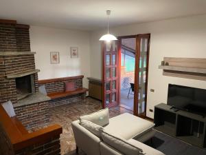 a living room with a couch and a fireplace at Residenza Ticino in Oleggio