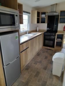 a kitchen with a refrigerator and a sink at The retreat in Carlisle