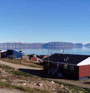 a small town on a hill with a body of water at Tent in ices in Nibe