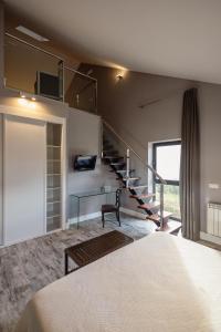 a bedroom with a staircase and a bed at A Finca Hotel in Barreiros
