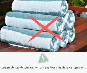 a stack of towels with a red x at Le Mas du Mont Ventoux in Malaucène +26 photos