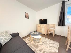 a living room with a couch and a table at Le Mas du Mont Ventoux in Malaucène