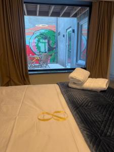 a bedroom with a bed with two towels and a window at Modern Ground Floor Apartment in Ghent