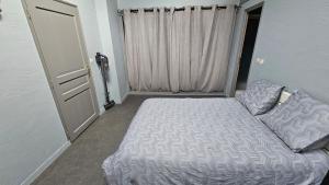 a small bedroom with a bed and a door at Appartement paisible in Saint-Cyprien +1 photo