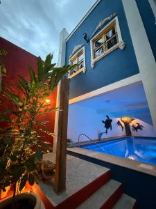 a house with a painting on the side of it at Imperialis Boutique Hotel in Canavieiras