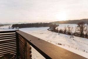 a view of a snow covered field from a balcony at Scheune am Bio-Bauernhof in Sankt Georgen bei Salzburg
