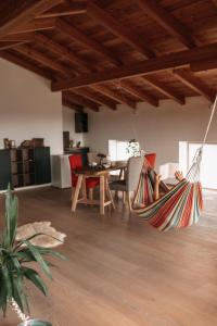 a hammock hanging from a ceiling in a living room at Scheune am Bio-Bauernhof in Sankt Georgen bei Salzburg