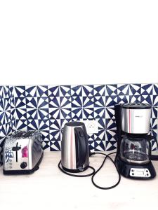 two toasters and a toaster on a kitchen counter at Escapade Santorini Epinal in Épinal