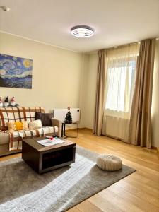 a living room with a couch and a coffee table at Alpine Charm Borovets Apart in Borovets