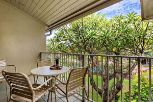 a table and chairs on a balcony with a view at Napili Shores E239 in Lahaina