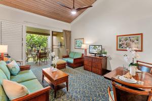 a living room with a couch and a table at Napili Shores E239 in Lahaina +38 photos
