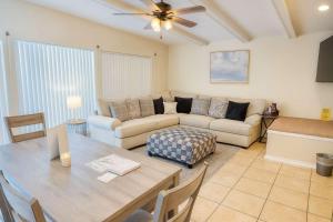 a living room with a table and a couch at Bay View Great Deck Pool 2 levels & 3 bedr condo in South Padre Island