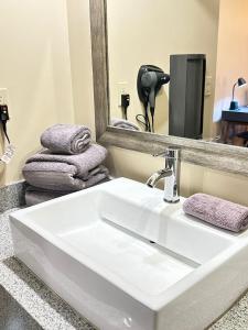 a bathroom with a white sink and a mirror at Hotel Boutique Querencia in Tijuana +18 photos