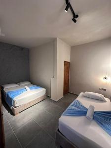 a bedroom with two beds in a room at Hotel Kyros by 70 in Medellín