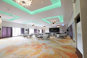 a banquet hall with tables and chairs on a large rug at The Oriental Hotel Legazpi in Legazpi