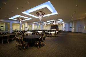 a banquet hall with tables and chairs in a room at The Oriental Hotel Legazpi in Legazpi +80 photos