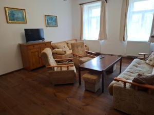 a living room with a couch and chairs and a table at Statek Vranč in Bítov