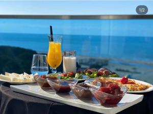 a table with plates of food and drinks on a table at Hotel Miami II in Golem