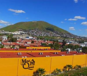 a view of a city with a mountain in the background at Hotel Boutique Querencia in Tijuana