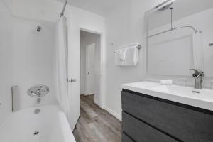 a white bathroom with a sink and a mirror at Magic Castle Hotel in Los Angeles +20 photos
