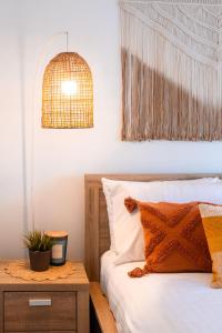 a bedroom with a bed and a pendant light at Oceanview Beach Shack with Pool & Walk to Dining in Aldinga Beach