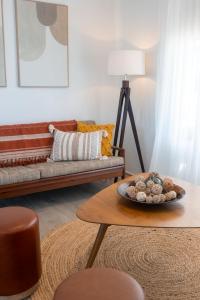 a living room with a couch and a table at Oceanview Beach Shack with Pool & Walk to Dining in Aldinga Beach +54 photos