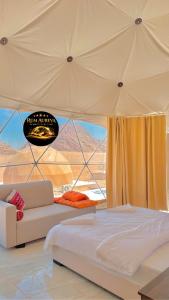 a bedroom with a bed and a couch in a tent at Star night in Disah
