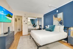 a bedroom with a large bed and a blue wall at Magic Castle Hotel in Los Angeles