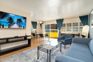 a living room with a blue couch and a table at Magic Castle Hotel in Los Angeles