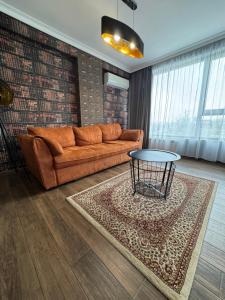 a living room with a couch and a table at Avenue Aparthotel in Sofia