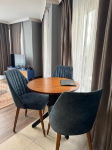 a table with two chairs and a table with a book on it at Avenue Aparthotel in Sofia +45 photos