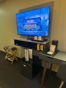 a large television on a desk in a room at Hotel Boutique Querencia in Tijuana