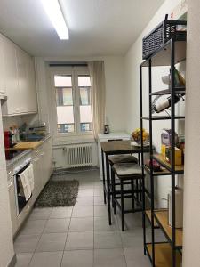a kitchen with a table and some chairs in it at Central Cozy Rooms in Zurich