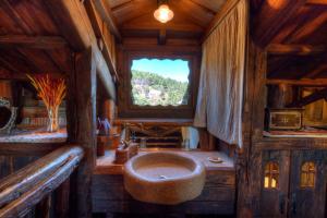 a bathroom with a large sink in a wooden house at Prada a Tope - Palacio de Canedo in Canedo +83 photos