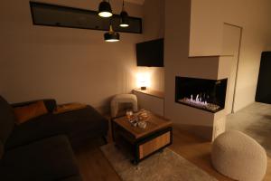 a living room with a couch and a fireplace at Chez Martine & Pierre in Baillonville