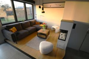a living room with a couch and a fire place at Chez Martine & Pierre in Baillonville